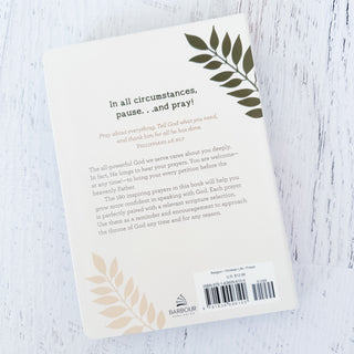 Bookback with text and leaf designs on a light wooden surface