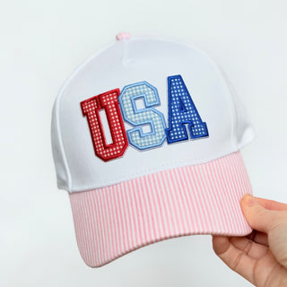 White cap with 'USA' in red and blue on a white background