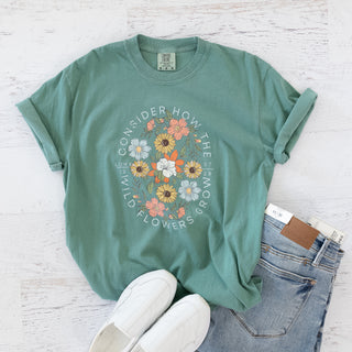 Green Consider How the Wild Flowers Grow t-shirt with floral graphic and scripture text
