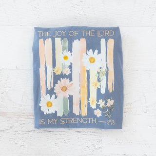 Blue t-shirt with The Joy of the Lord is My Strength text and floral brushstroke graphic