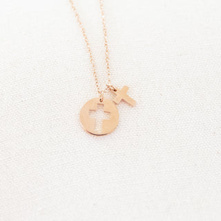 Rose gold necklace with a unique pendant on a light gray background