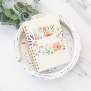 Love Is Patient Love Is Kind spiral wire bound ivory journal on a white wooden tray with eucalyptus