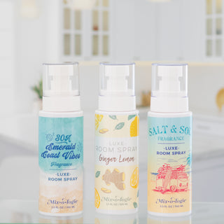 Three Mixologie Luxe room spray bottles in Emerald Coast Vibes Ginger Lemon and Salt and Sol scents