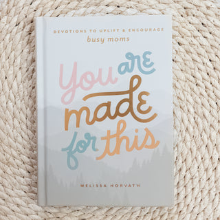 You Are Made for This Devotions to Uplift & Encourage Busy Moms book with soft pastel lettering on woven natural background