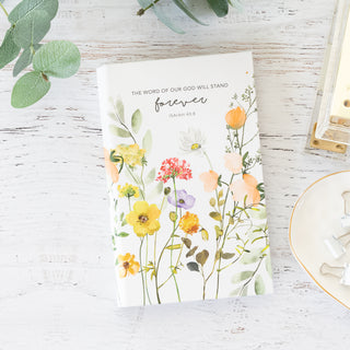 The Word of Our God will Stand Forever Isaiah 40:8 notepad with floral watercolor design on a white wooden surface