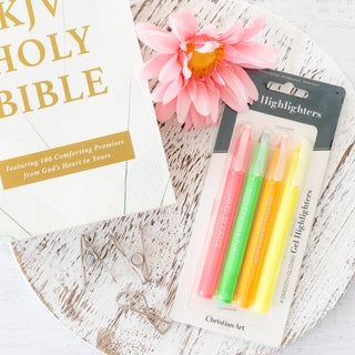 Gel highlighters in packaging next to a KJV Holy Bible and a pink flower