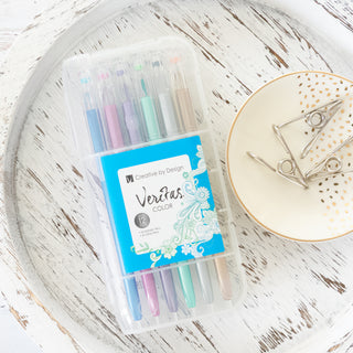 Veritas Colors Metallic and Glitter Pens set of 12 in a clear plastic case on a white wooden tray