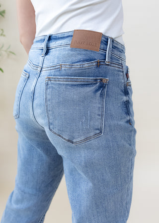 Back view of Judy Blue vintage wash slim fit light blue jeans with brown leather brand patch