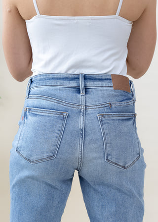 Back view of Judy Blue vintage wash slim fit light blue jeans with two pockets and leather brand patch