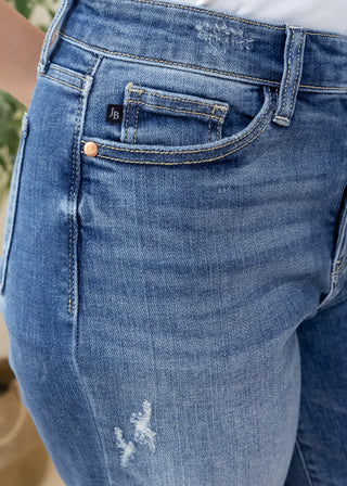 Close up of Judy Blue Classic 90s mid rise high waisted blue jeans showing pocket detail and copper rivet