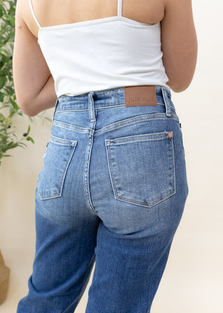 Back view of Judy Blue classic 90s mid rise high waisted blue jeans with leather brand patch