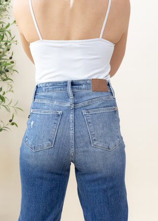 Back view of Judy Blue Classic 90s mid rise high waisted blue jeans with brown leather brand patch