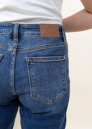 Back view of Judy Blue dark mid rise destroy slim denim jeans with brown leather brand patch