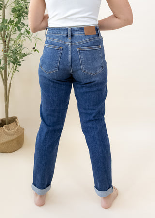 Back view of Judy Blue dark mid rise slim denim jeans with cuffed hems