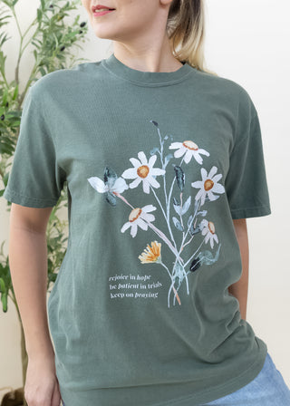 Dark green Rejoice in Hope Be Patient in Trials Keep on Praying graphic tee with a floral illustration