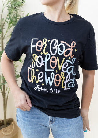 Person wearing black For God So Loved the World graphic tee with colorful text and John 3 16 print