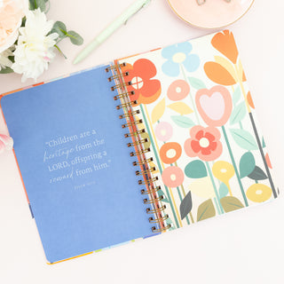 Open Moms Faith Journey journal with blue page featuring Psalm 127 3 text and floral pattern page