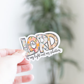 The Lord is my Light and My Salvation sticker with floral pattern lettering held by a hand