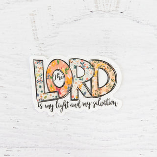 The Lord is my Light and My Salvation sticker with floral patterned letters on a white wood background