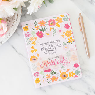 Pink and floral scripture set of three blank notebooks with a rose gold pen on a marble surface