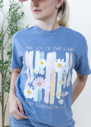 Blue t-shirt with The Joy of the Lord is My Strength text and daisy floral graphic