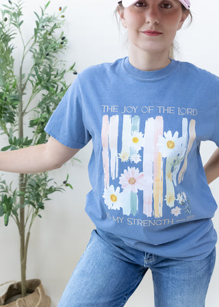 Blue t-shirt with The Joy of the Lord is My Strength Neh 8:10 text and daisy floral graphic