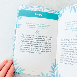 Open book with a page titled 'Hope' held by a hand on a light blue background