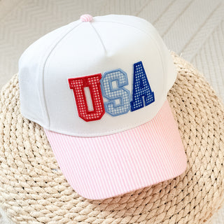 White cap with 'USA' in red and blue on a woven surface