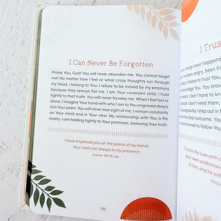Open book with a prayer on a white surface