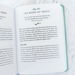 Open book with text on a white surface