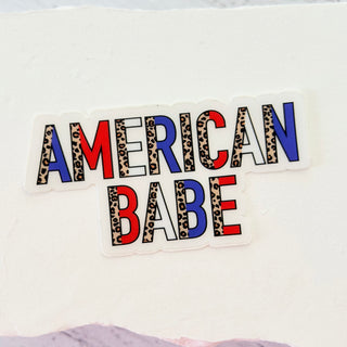 Sticker with 'AMERICAN BABE' text on a white background