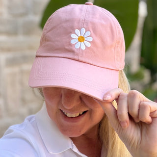 Single White Danity Daisy on Mauve Color Baseball Cap worn with a smile, showing embroidered daisy detail