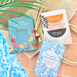 Three books on a textured surface with decorative elements
