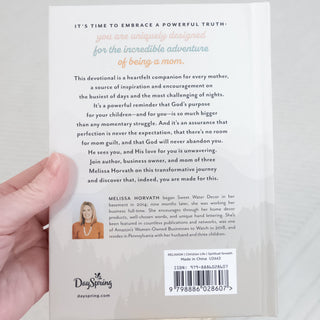 Hand holding Faith & Self-Care Gift Box for Moms on Mother's Day devotional book with inspirational text and author photo on back cover.